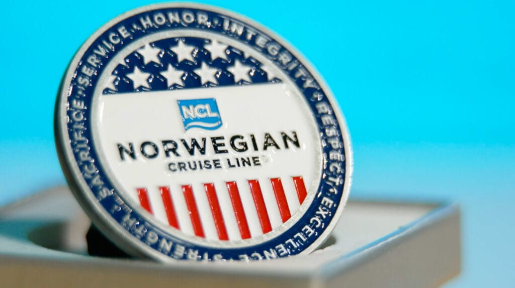 An NCL Challenge Coin.  In addition to a generous Military & Veteran Discount, NCL provides a welcome packet, including this challenge coin.