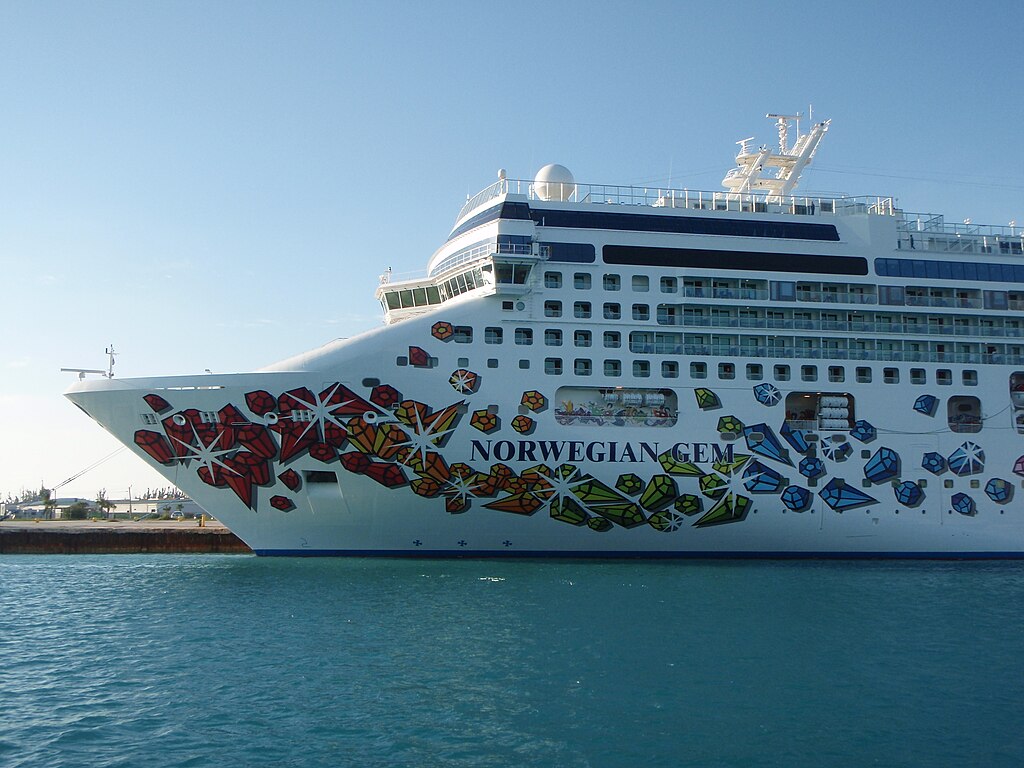Norwegian Gem cruise ship docked at port with multiple decks visible from the side