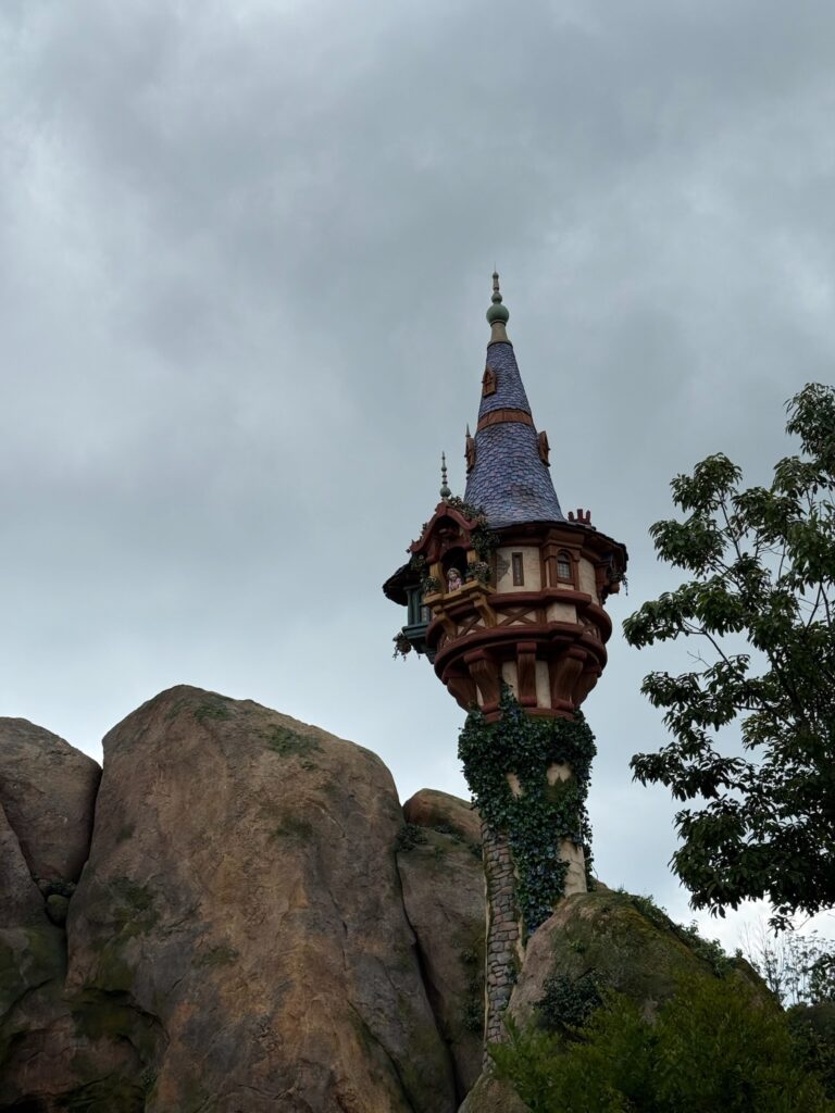 Rapunzel Tower – Fantasy Springs (Tokyo DisneySea) Rapunzel in her tower at Fantasy Springs, Tokyo DisneySea, with ivy-covered base and rocky landscape