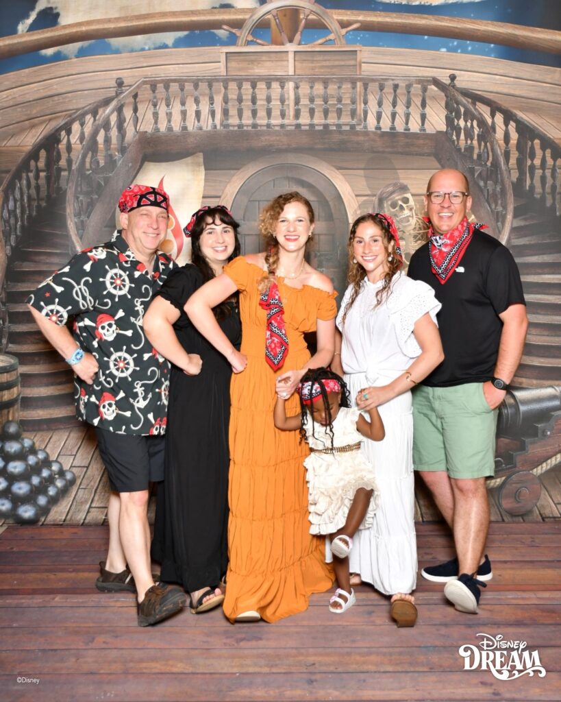 Family wearing pirate themed outfits during Pirate Night on a Disney Cruise Line sailing