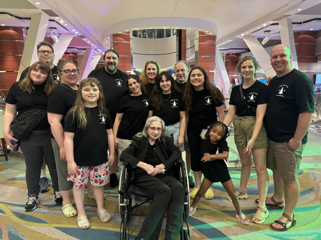 Large multigenerational family wearing matching black, themed t-shirts on a Oasis of the Seas