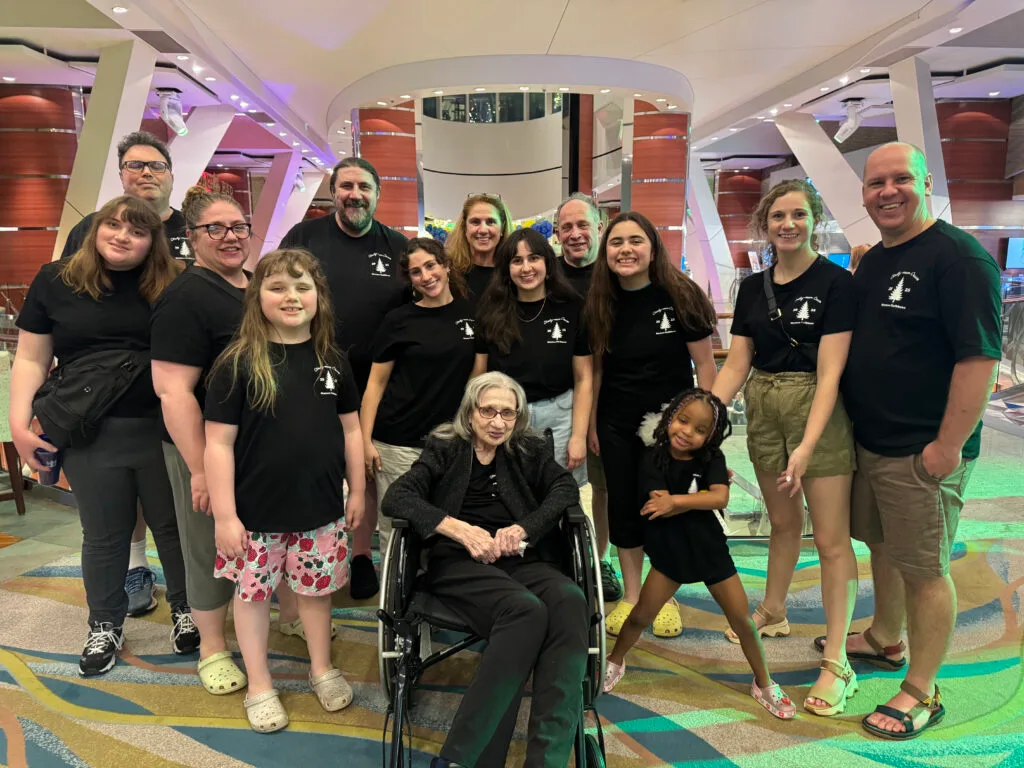 Large multigenerational family wearing matching black, themed t-shirts on a Oasis of the Seas