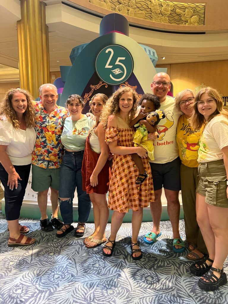 Family wearing Winnie the Pooh inspired Disney bounding outfits during a cruise vacation photo