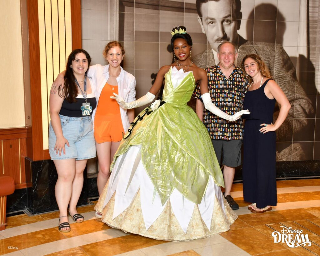 Family meeting Princess Tiana during a character experience aboard the Disney Dream cruise ship