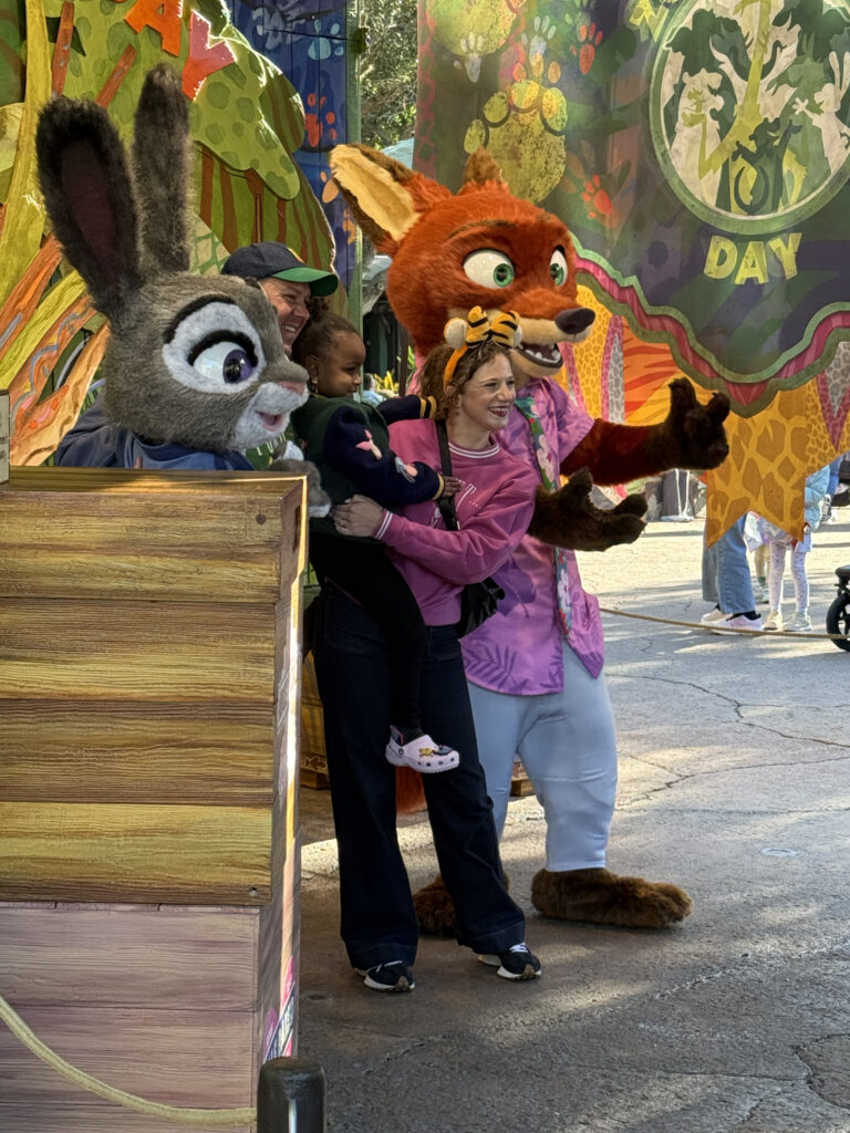 Family meeting Judy Hopps and Nick Wilde from Zootopia at a Disney park.