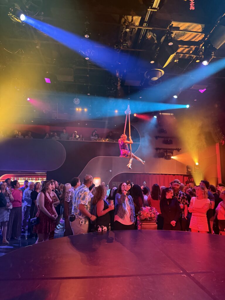Dancers Perform Aerial Acts Under Vibrant Lights During Persephone on Board Virgin Voyages Scarlet Lady