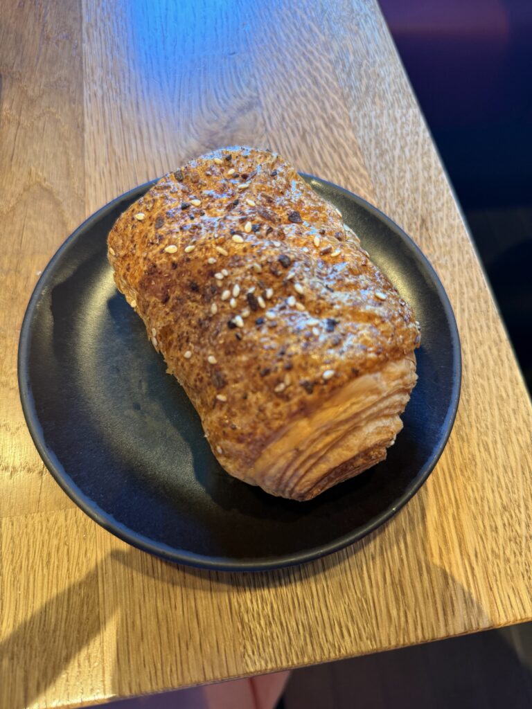 Enjoying a Freshly Baked Croissant at Breakfast on Board Virgin Voyages Scarlet Lady While Cruising in the Caribbean