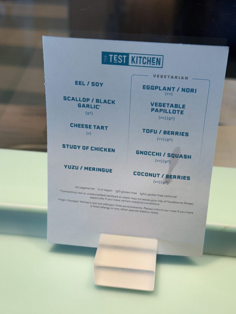 Menu From Test Kitchen Featuring Dishes With Eel Scallop Cheese Tofu and Coconut Presented on Virgin Voyages Scarlet Lady