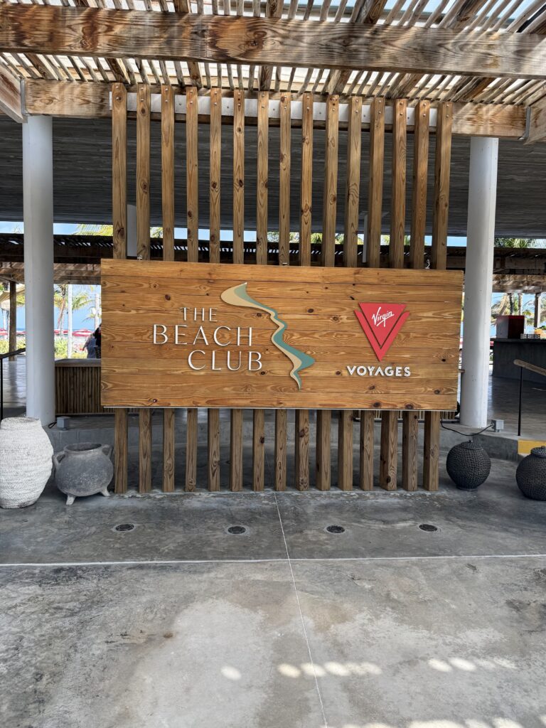 Sign at the Entrance to the Beach Club on Bimini Island Highlighting Virgin Voyages Branding and Welcoming Guests